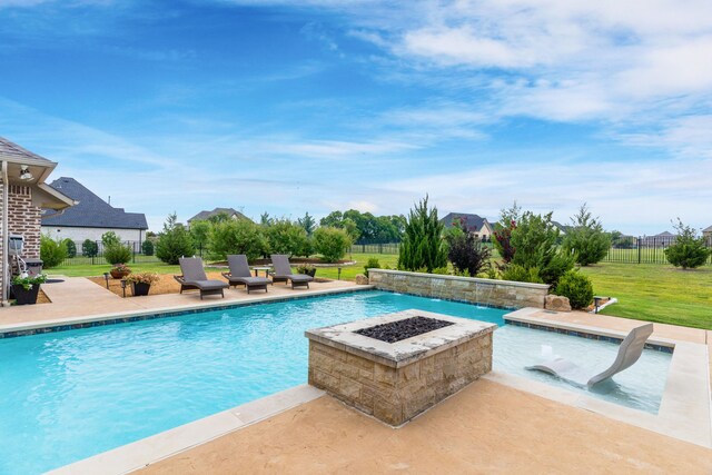 view of swimming pool featuring a patio area, a hot tub, a yard, pool water feature, and a fire pit