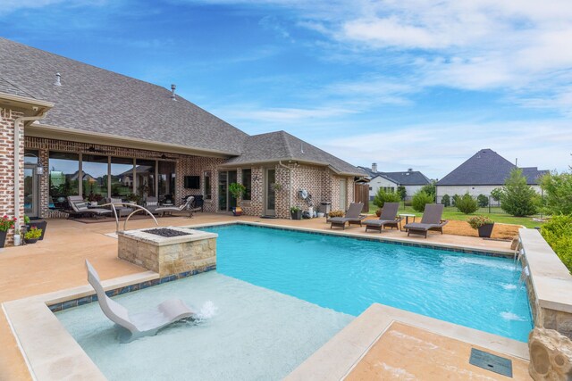 view of swimming pool with a water slide, a fire pit, a patio, and pool water feature