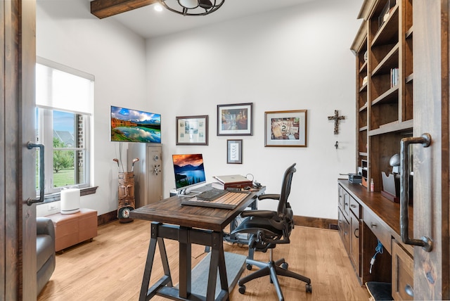 home office with vaulted ceiling with beams and light hardwood / wood-style flooring