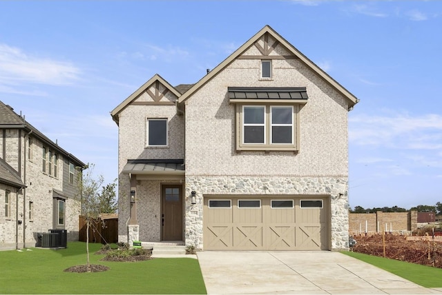 view of front of home with a garage, a front yard, and central air condition unit