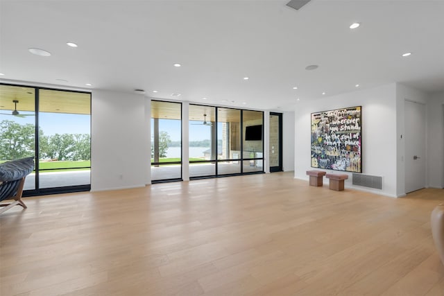 interior space featuring expansive windows and light hardwood / wood-style flooring