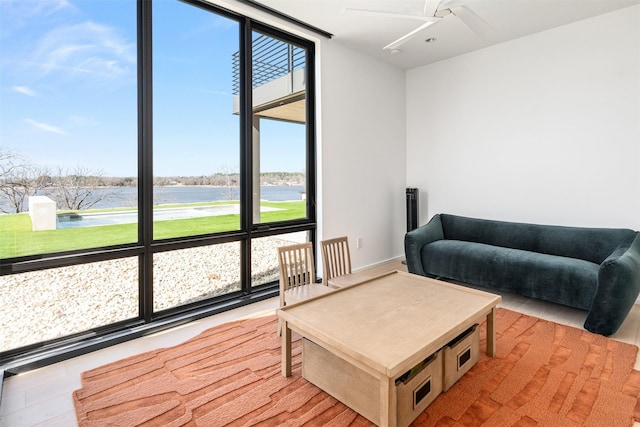 living room featuring a water view and a wall of windows