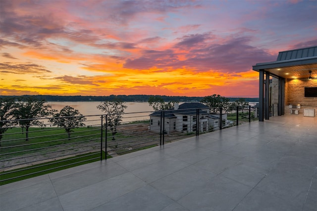 exterior space featuring a water view and area for grilling