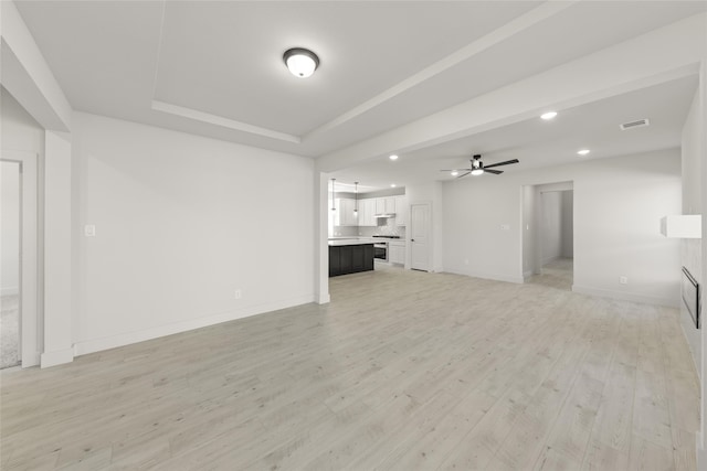 unfurnished living room with light wood-type flooring and ceiling fan