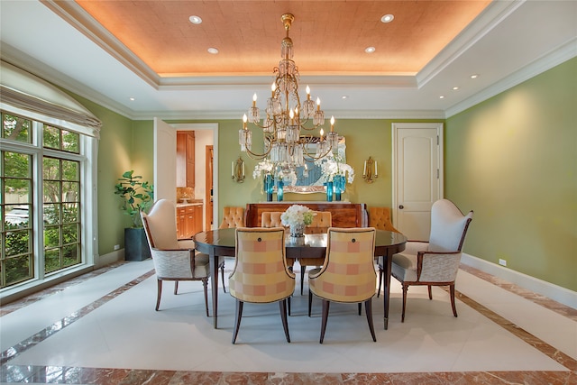 dining area featuring light tile patterned flooring, an inviting chandelier, ornamental molding, and a raised ceiling