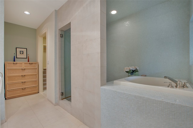 bathroom with separate shower and tub and tile patterned flooring