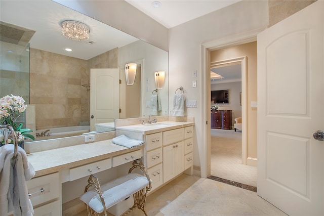 bathroom featuring vanity, tile patterned flooring, and tiled shower / bath combo