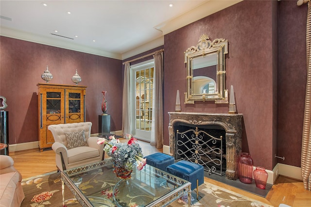 sitting room with a premium fireplace and light wood-type flooring