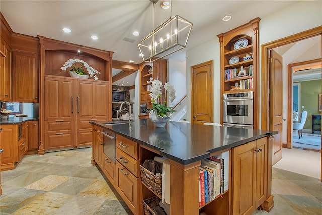 kitchen with an inviting chandelier, an island with sink, hanging light fixtures, oven, and sink