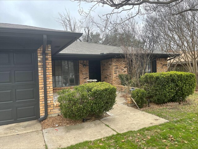 view of front of house with a front yard and a garage