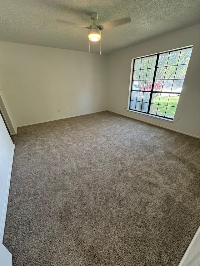 carpeted empty room with a textured ceiling and ceiling fan