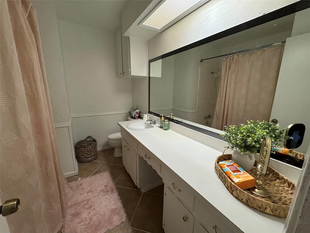 bathroom with vanity, toilet, tile patterned floors, and walk in shower