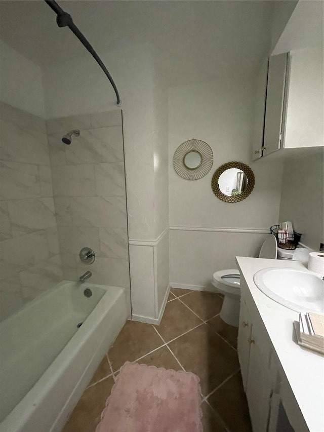 full bathroom featuring vanity, tiled shower / bath combo, tile patterned floors, and toilet