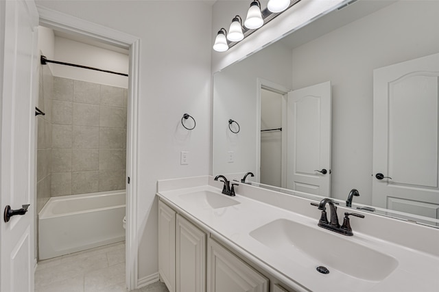 full bathroom featuring tile patterned floors, toilet, tiled shower / bath combo, and vanity