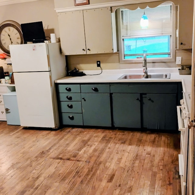 308 County Road 1296, Morgan, TX 76671 - kitchen featuring white appliances, light wood-style floors, and light countertops