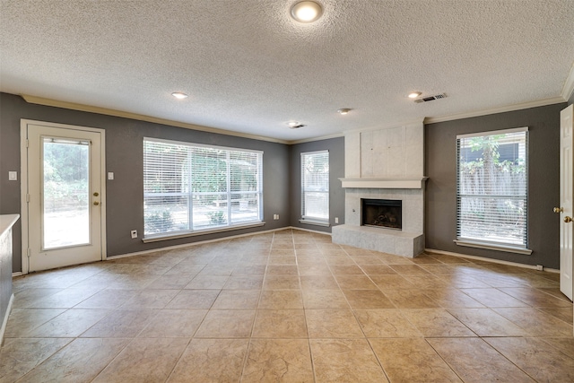 unfurnished living room featuring a fireplace, a healthy amount of sunlight, light tile patterned floors, and crown molding