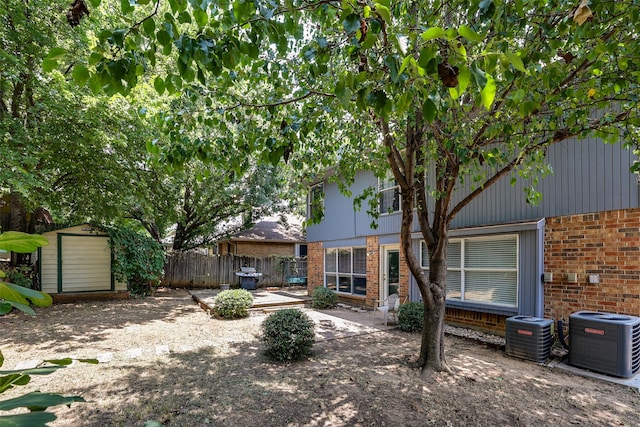 back of house with a patio, a shed, and cooling unit