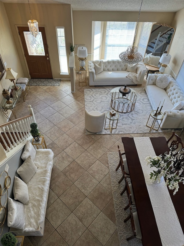 tiled living room featuring a textured ceiling