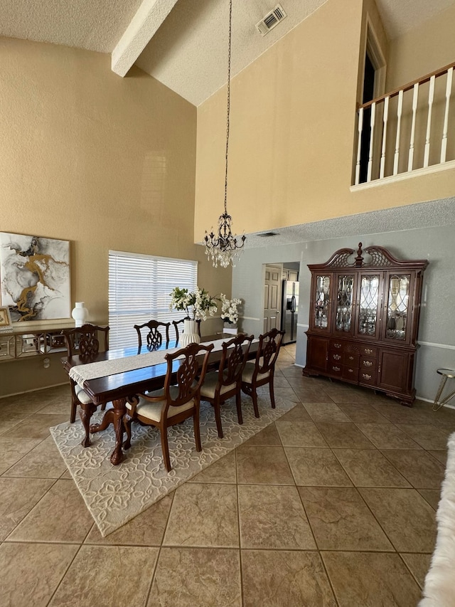 tiled dining area with beamed ceiling, a textured ceiling, high vaulted ceiling, and a chandelier