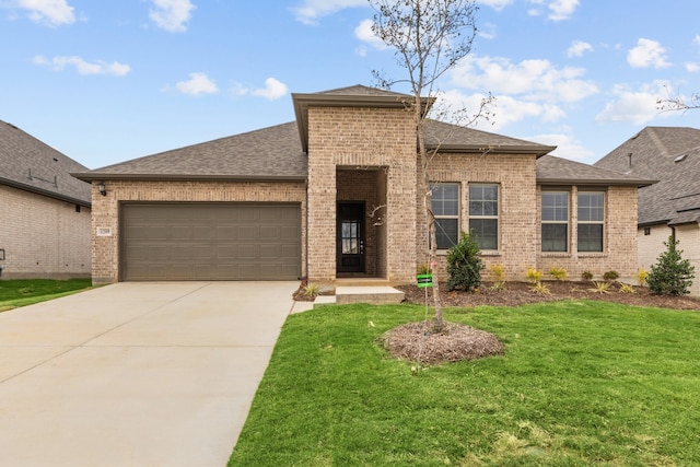 view of front of property with a front yard and a garage