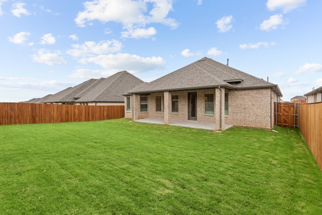 rear view of property with a patio area and a lawn