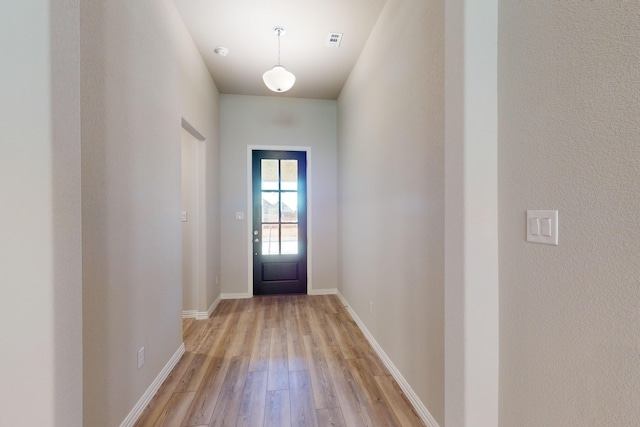 doorway with light wood-type flooring