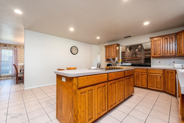 kitchen with light tile patterned flooring, tasteful backsplash, and a kitchen island