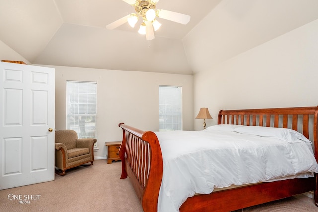 bedroom featuring light colored carpet, vaulted ceiling, and ceiling fan