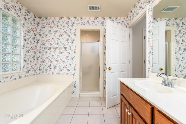 bathroom featuring vanity, independent shower and bath, and tile patterned floors