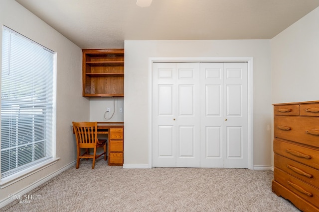 office area featuring light carpet