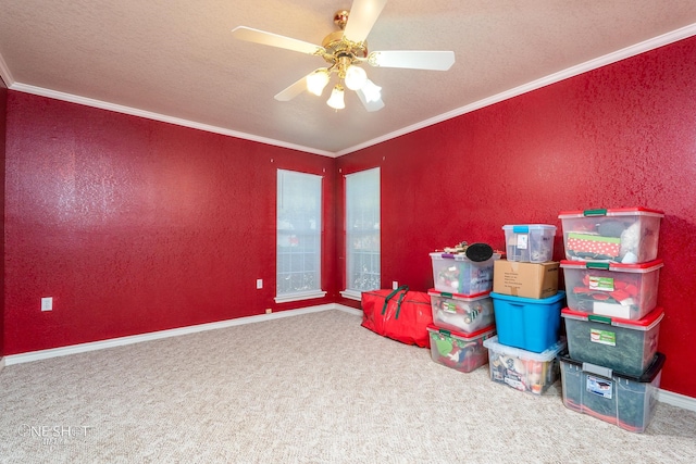 game room featuring carpet flooring, a textured ceiling, ornamental molding, and ceiling fan