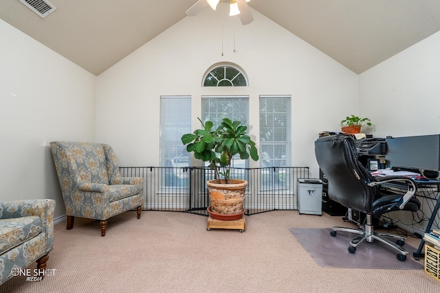 home office featuring carpet, ceiling fan, and vaulted ceiling