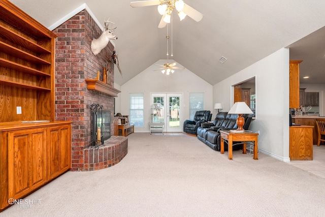 living room with brick wall, ceiling fan, a brick fireplace, and light colored carpet