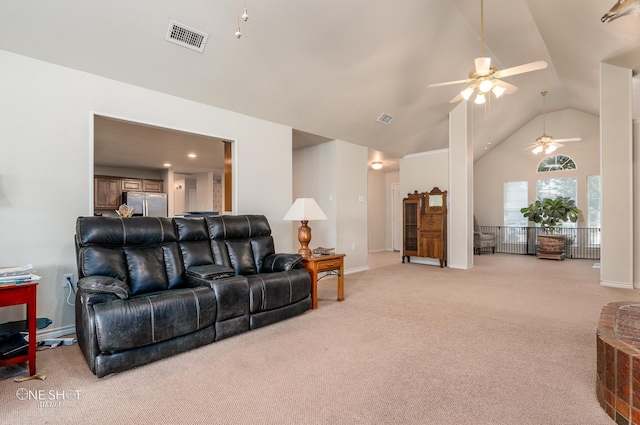 living room featuring light colored carpet, ceiling fan, and high vaulted ceiling