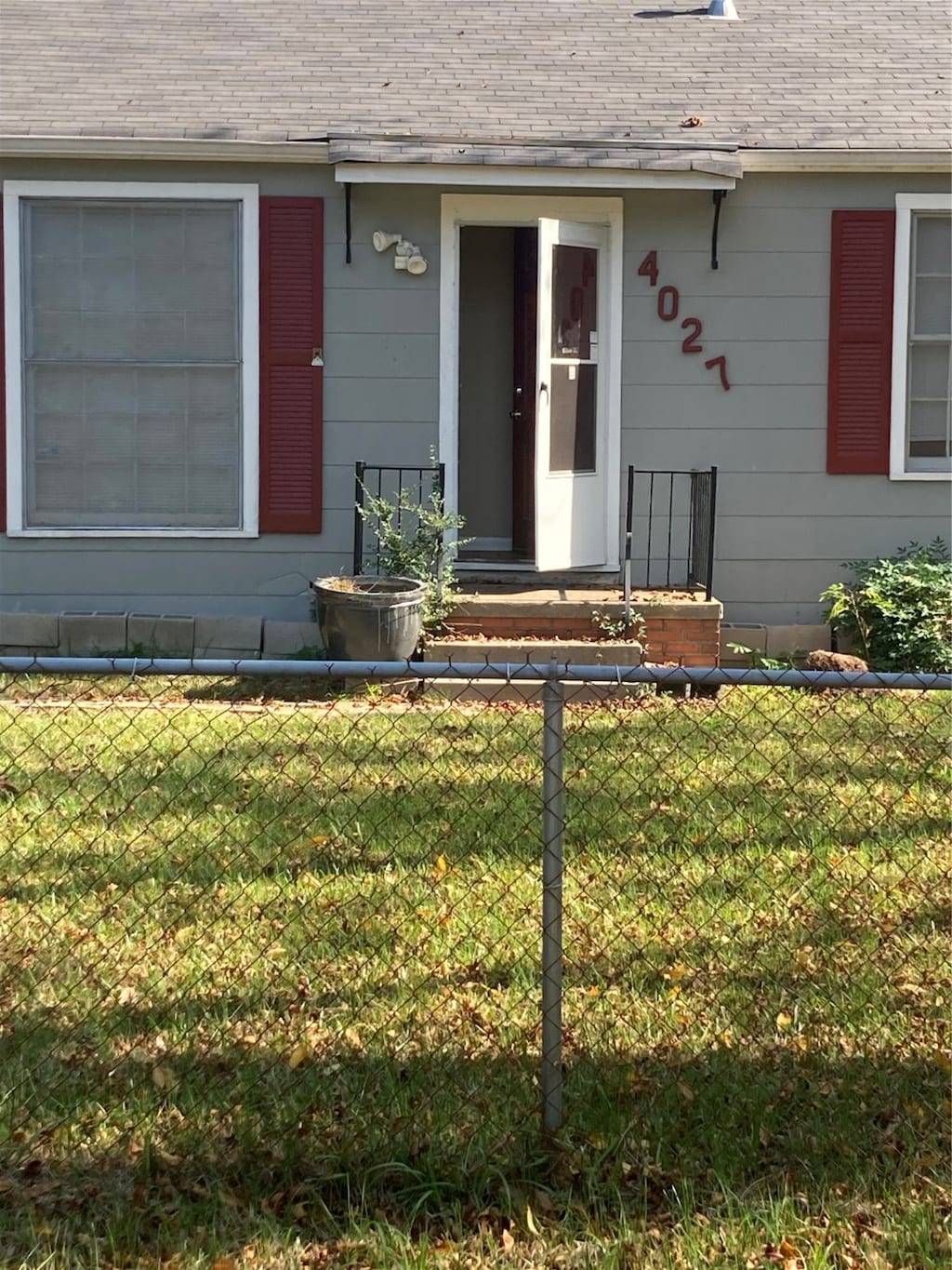 entrance to property with a lawn