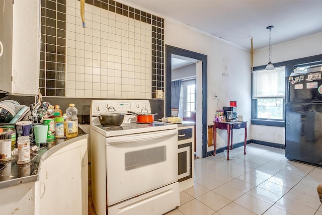 kitchen with light tile patterned floors, ornamental molding, white electric range oven, and decorative light fixtures