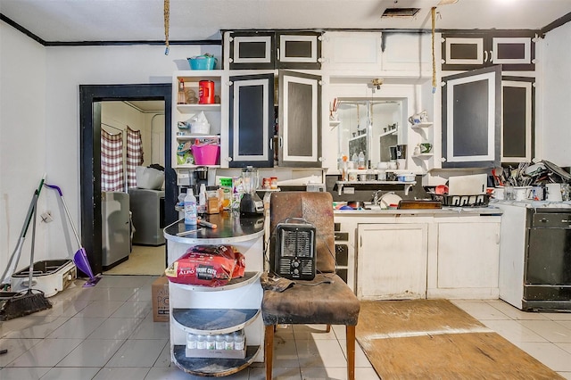 kitchen featuring light tile patterned floors and crown molding