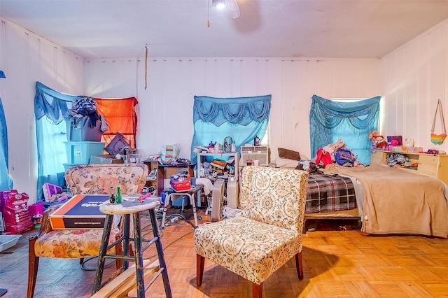 bedroom with ceiling fan, light parquet flooring, and multiple windows