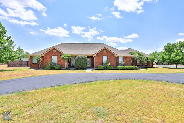 ranch-style home with a front lawn