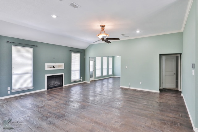 unfurnished living room with crown molding, dark wood-type flooring, ceiling fan, and vaulted ceiling