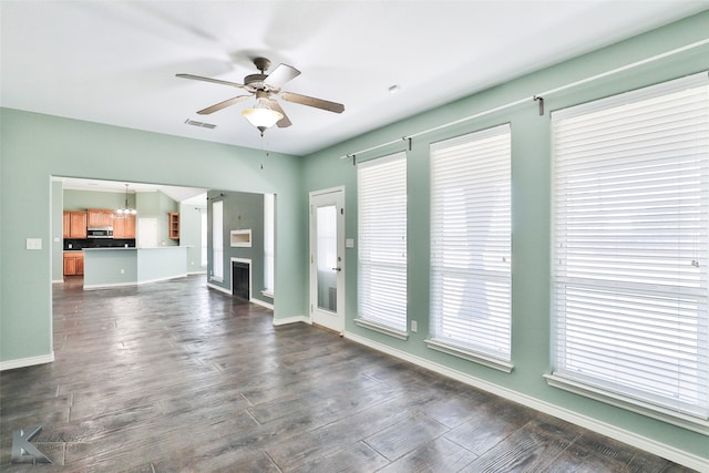 unfurnished room with ceiling fan and dark hardwood / wood-style floors