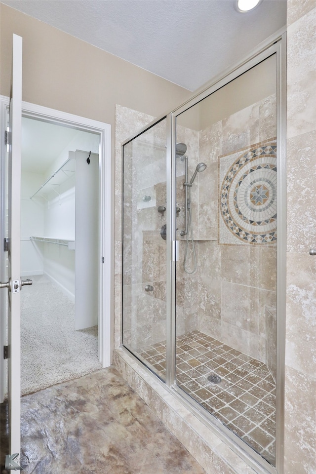 bathroom with a shower with door and tile patterned floors