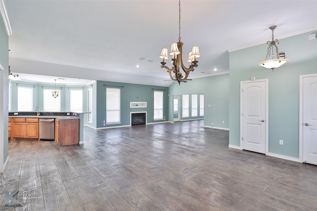 unfurnished living room featuring a notable chandelier, dark hardwood / wood-style flooring, and ornamental molding