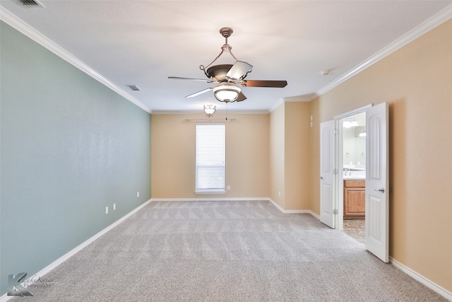 carpeted empty room featuring ornamental molding and ceiling fan