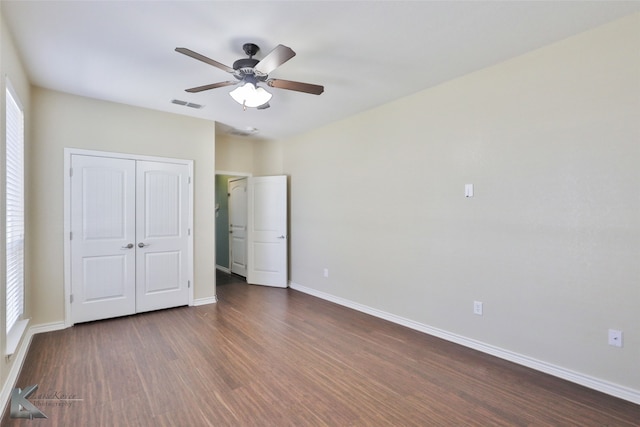 unfurnished bedroom featuring wood-type flooring, a closet, and ceiling fan