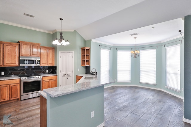 kitchen featuring stainless steel appliances, backsplash, a chandelier, and kitchen peninsula