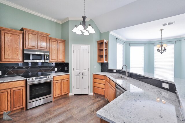 kitchen with stainless steel appliances, sink, tasteful backsplash, and a chandelier