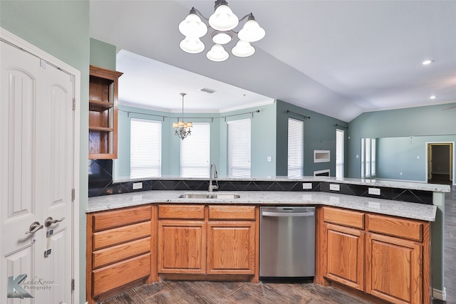 kitchen featuring a notable chandelier, stainless steel dishwasher, sink, light stone counters, and dark hardwood / wood-style floors