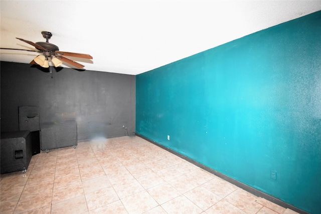 tiled spare room featuring ceiling fan