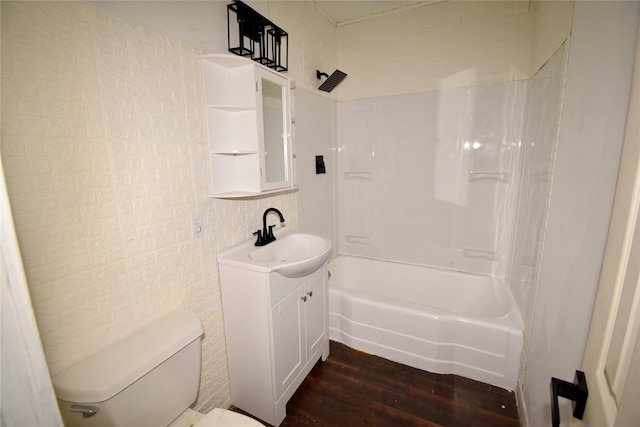 full bathroom featuring hardwood / wood-style floors, vanity, shower / washtub combination, and toilet